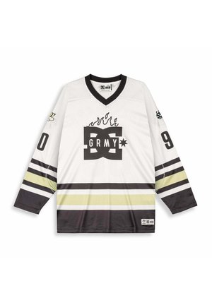 Langärmeliges weißes Hockeytrikot mit schwarzen und gelben Streifen, schwarzem Kragen, Flammendesign über dem "DC GRMY"-Logo und den Zahlen "0" und "9" auf den Ärmeln.