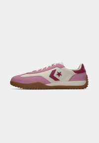 Pink and cream sneaker with a textured suede upper, featuring maroon accents and star logo, complemented by a brown rubber sole.