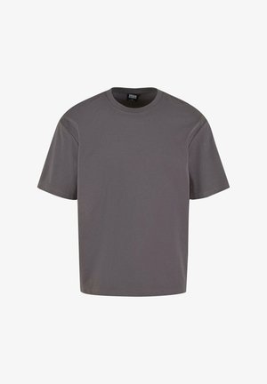 Tricou din bumbac gri, cu mâneci scurte, guler rotund și croială lejeră. Textură netedă, design minimalist, fără modele sau echipamente vizibile.