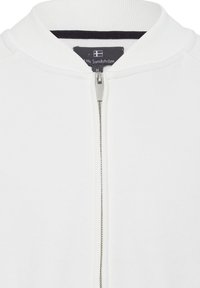 Witte hoodie met ritssluiting van een textuurstof, geribde kraag en een chroom rits. Heeft een zwart binnenwerk en een label bij de halslijn.