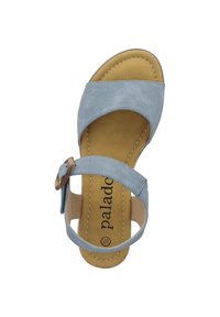 Light blue suede sandal with a flat sole. Features a buckle strap and crisscross design. Tan insole with logo and contrasting stitching.