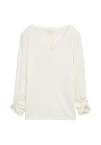 Camicia bianca a maniche lunghe con scollo tondo, tre bottoni sulla pattina e maniche arrotolate fissate con bottoni.