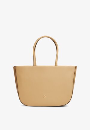 Beige leren shopper met ronde handvatten en een klein geprint logo gecentreerd vlak bij de onderkant aan de voorkant.