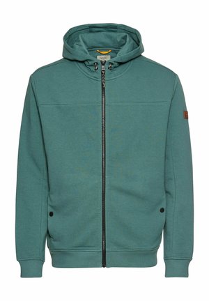 Teal zip-up hoodie with a drawstring hood, black zipper, side pockets, ribbed cuffs, and logo patch on the sleeve. Soft fabric texture.