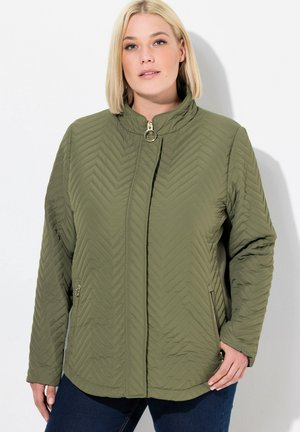 Olive green quilted jacket with a mandarin collar, featuring a zip front closure and side pockets with zipper accents, textured chevron pattern.