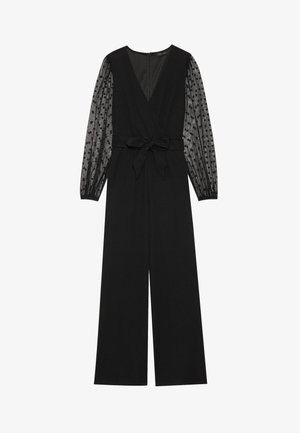 Combinaison noire avec un design croisé, manches longues transparentes à motif à pois et taille nouée. Tissu lisse et silhouette à jambe large.