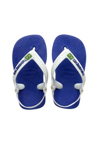 Chanclas azules con suelas texturizadas y correas de goma blanca. La marca en la correa incluye "Havaianas" y una pequeña bandera brasileña.