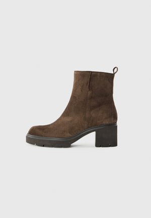 Brown suede ankle boots with a rounded toe, chunky black heel, and rear pull tab. Features a smooth texture and minimal stitching.