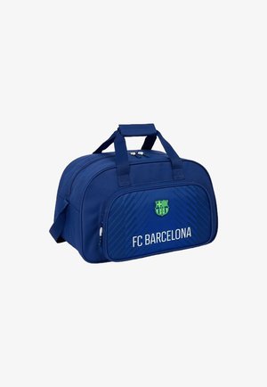 Borsa sportiva blu del FC Barcelona con manici superiori, tasca frontale con zip e logo sopra il nome del club su uno sfondo bianco.