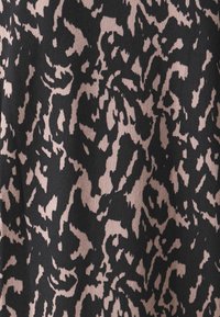 Black fabric featuring a pink abstract leopard print pattern. Soft texture with variations in shape and density throughout the design.