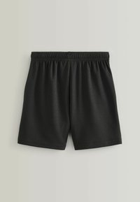 Pantaloni sportivi neri realizzati in tessuto a rete traspirante, con vita elasticizzata, vestibilità ampia e cuciture lisce.