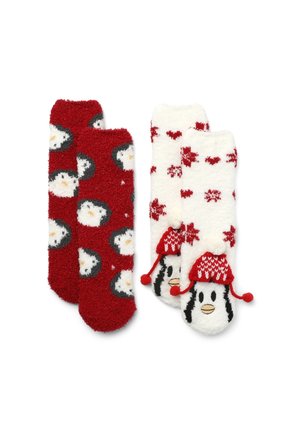 Due paia di calze: una rossa con facce di pinguino e l'altra bianca con fiocchi di neve rossi e un disegno di pinguino con un cappellino pompon. Texture morbida e pelosa.