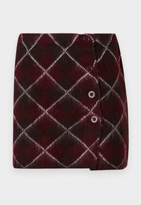 Jupe tricotée bordeaux et brun foncé avec motif en losange, comprenant des accents blancs et trois boutons sur le côté pour la fermeture.