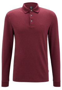 Langarm-Polohemd in Burgunderrot, aus Strickstoff gefertigt. Verfügt über einen Kragen, einen Drei-Knopf-Verschluss und ein gesticktes Logo.
