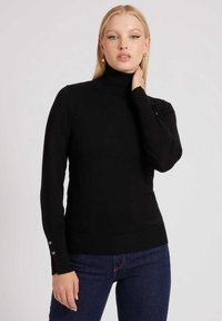 Maglione nero a collo alto con maniche lunghe, polsini a coste con bottoni decorativi e una texture liscia. Logo del marchio discreto sull'orlo.