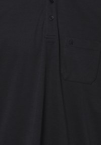 Schwarzes Polohemd aus strukturiertem Stoff, mit Knopfleiste vorne, kurzen Ärmeln und einer linken Brusttasche mit gesticktem Logo.
