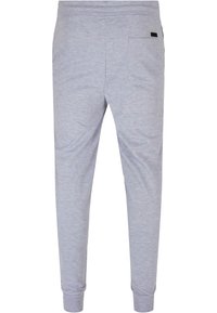 Pantalons de survêtement gris en mélange de coton doux. Présentent une taille élastique, des jambes resserrées et une poche arrière unique. Design minimaliste.