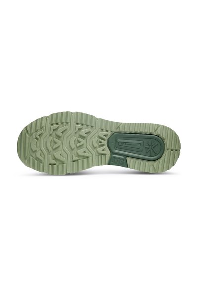 Grön gummisula med texturerat mönster, med upphöjda sektioner för grepp och centralt logotypdetalj. Utformad för bra fäste på olika ytor.