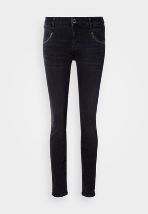 Čierne denimové džínsy so slim fit strihom, vybavené prednými vreckami a svetlými stehovými detailmi. Hladká textura a rovný strih nohavíc. Žiadne ozdoby.
