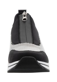 Black and white athletic shoe with a sleek design, featuring a zippered closure, textured panels, and a rubber sole with white stripes.
