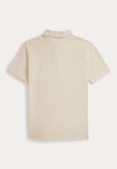 Μπεζ κοντομάνικο πόλο πουκάμισο με κλασικό γιακά, που διαθέτει ομαλή υφή και ελάχιστες ραφές, σχεδιασμένο για άνετη εφαρμογή.