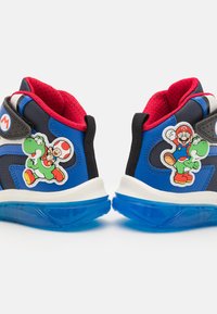 Blue and black athletic shoes with red accents, featuring cartoon character patches of Mario and Yoshi. Textured fabric and rubber sole.