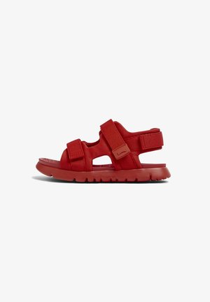 Red sports sandals with textured fabric upper, dual adjustable straps, and cushioned sole. Open design with cutouts for breathability.