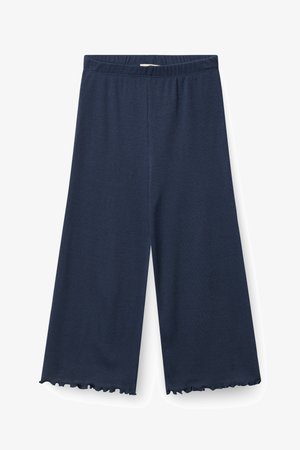 Pantalon large bleu marine avec taille élastique et ourlets à volants, fabriqué en tissu côtelé.