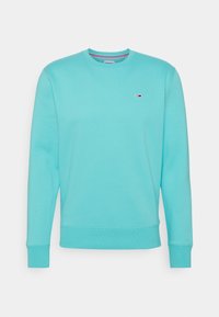 Sudadera de cuello redondo azul claro con mangas largas y un pequeño logotipo rojo, blanco y azul en el lado izquierdo del pecho.