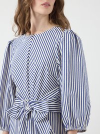 Blue and white striped blouse with puffed sleeves, featuring a waist tie and gathered detailing on the shoulders. Soft, textured fabric.