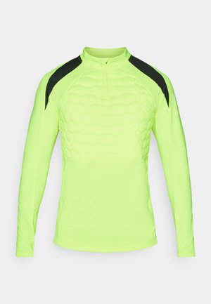 T-shirt de sport à manches longues en jaune néon vif avec un motif hexagonal texturé sur la poitrine et des accents noirs sur les épaules.