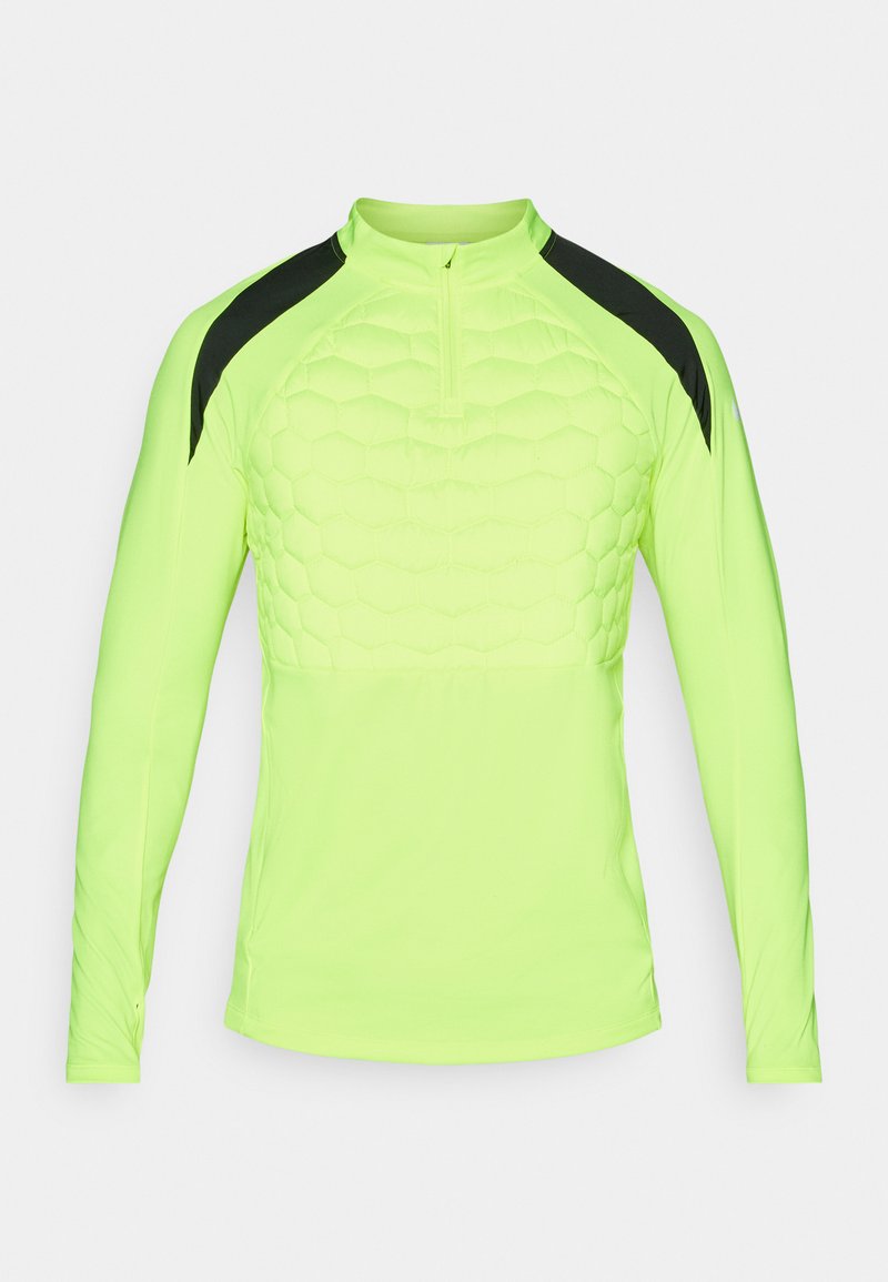 Maglietta sportiva a maniche lunghe di un brillante giallo neon con un motivo esagonale testurizzato sul petto e dettagli neri sulle spalle.