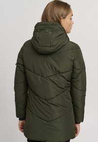Olive green puffer jacket with horizontal quilted design, a hood, and side pockets, featuring a smooth, glossy finish and fitted silhouette.