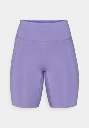 Shorts de sport violets avec une taille haute, un design ajusté, une texture lisse et des détails de couture subtils sur les côtés.