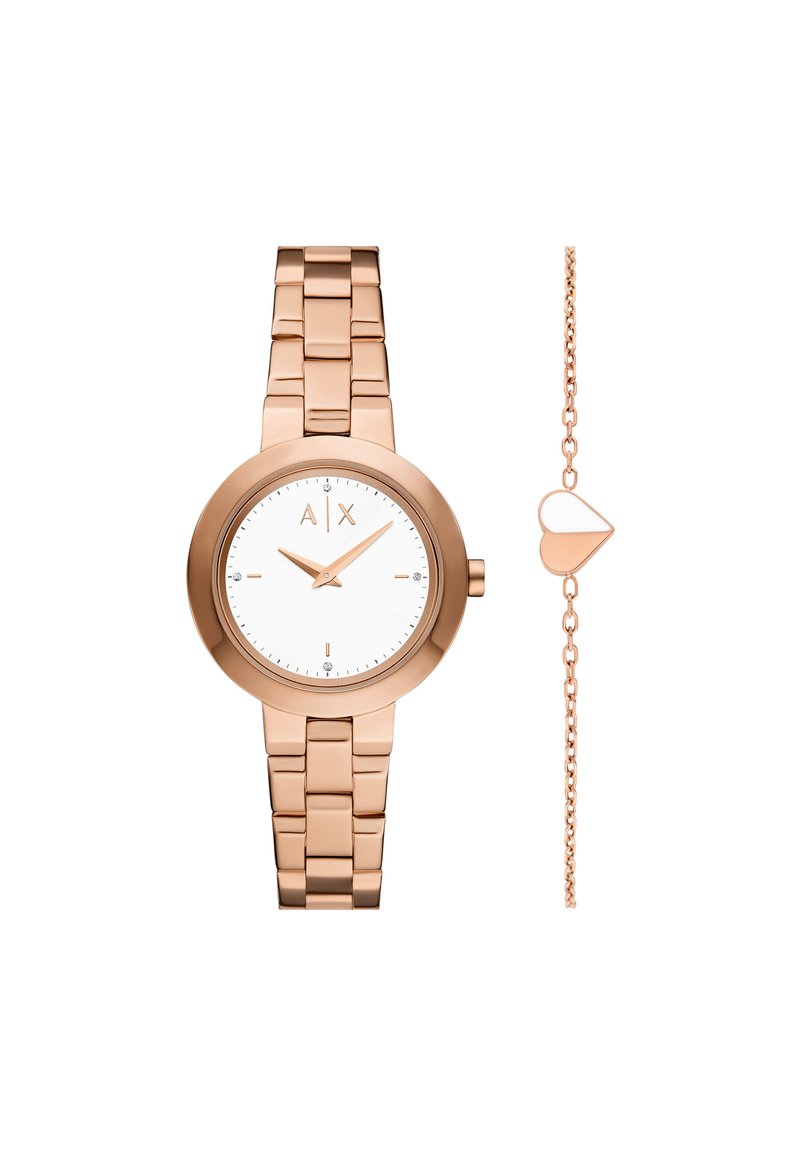 Roséguldfärgad klocka med en minimalistisk vit urtavla, metallarmband och ett armband med hjärtformade berlocker bredvid.