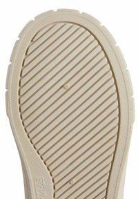 Sole in gomma beige con scanalature orizzontali e verticali, dotata di punta arrotondata e superficie testurizzata per una maggiore aderenza.