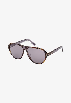 Gafas de sol carey con lentes grises, que presentan una forma redondeada, patillas finas y acentos metálicos cerca de las bisagras.