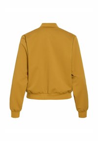 Veste bomber jaune moutarde, tissu lisse, poignets et ourlet côtelés, design sans col, coupe décontractée, construction simple, sans éléments métalliques visibles.