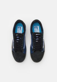 Blue and black sneakers with a suede and mesh upper, featuring a rounded toe, black laces, and blue insole. No visible patterns or logos.