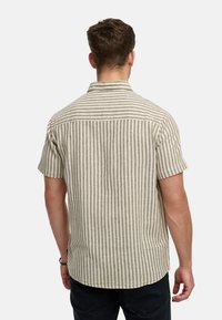Short-sleeve shirt with vertical beige and grey stripes, button-down collar, and a straight hem. Made of lightweight fabric.