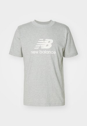 Light gray cotton t-shirt featuring short sleeves, crew neckline, and white "New Balance" logo prominently displayed on the front.