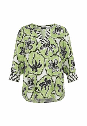 Long sleeve blouse with green and white geometric patterns featuring black palm tree and flower motifs, V-neck with patterned trim.