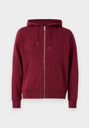 Burgundy vetoketjuhuppari, jossa on nyörihuppu, etutaskut, joustavat hihansuut ja helma. Valmistettu pehmeästä ja mukavasta kankaasta.