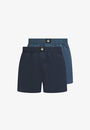 Zwei Paare Männer-Boxershorts in Marineblau und Hellblau. Hergestellt aus glattem Stoff, mit elastischen Bündchen und einer Knopfdetaillierung vorne.