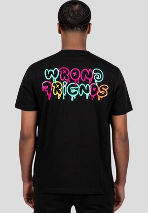 Black t-shirt featuring colorful "WRONG FRIENDS" text in vibrant dripping letters on the back. Classic crew neck design.