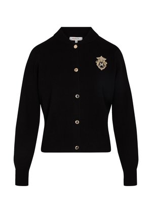 Gilet noir en tricot doux, avec un col rond, des boutons à l'avant et un emblème en or sur la poitrine gauche. Vendu par Morgan.