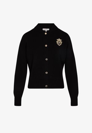 Cardigan nero in morbido knit, con colletto rotondo, bottoni frontali e un emblema dorato sul lato sinistro del petto. Venduto da Morgan.