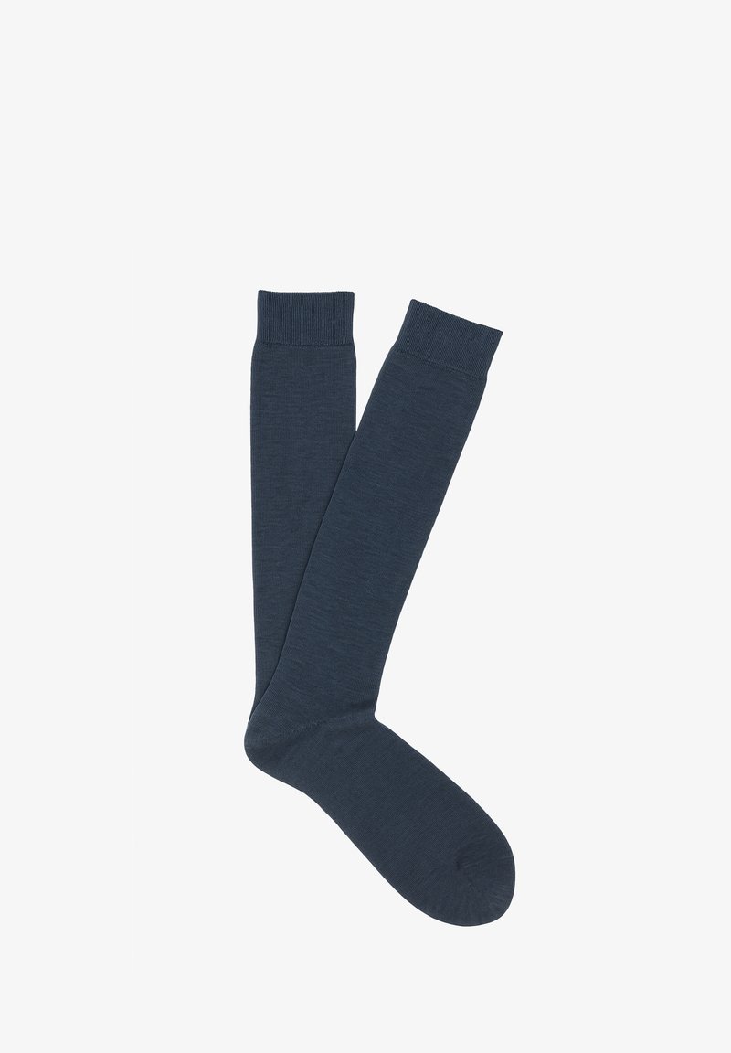 Calzini alti fino al ginocchio di colore blu scuro, realizzati in materiale morbido ed elastico con un polsino a coste sulla parte superiore e una texture liscia su tutta la lunghezza.
