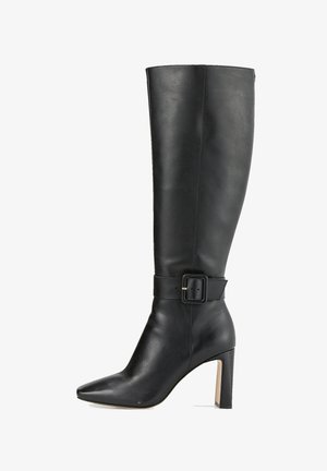 Botte noire en cuir hauteur genou avec un bout pointu, un talon bloc et une sangle décorative avec une boucle carrée autour de la cheville.