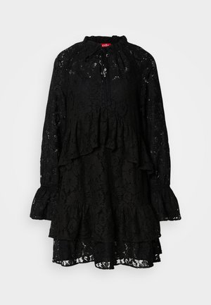 Vestido negro de encaje con mangas largas, volantes en los niveles, un cuello alto con lazos y un patrón floral texturizado en todo el vestido.